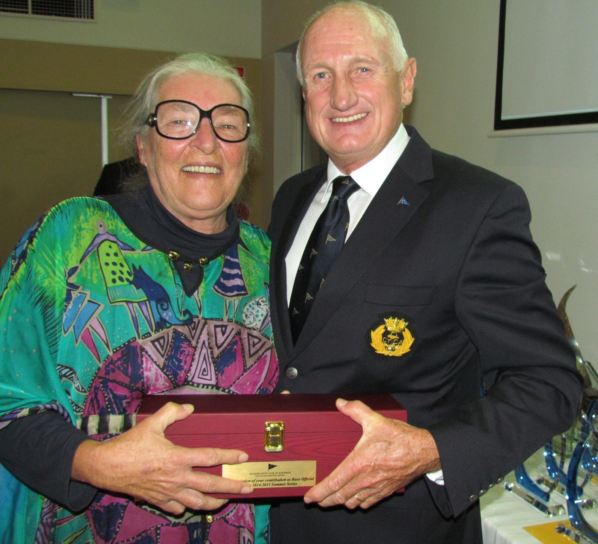 Robyn receives a gift from Commodore Noel Cornish for her contribution as Race Official in the 2014-15 Summer Series.  (L-R) Robyn Morton, Noel Cornish.